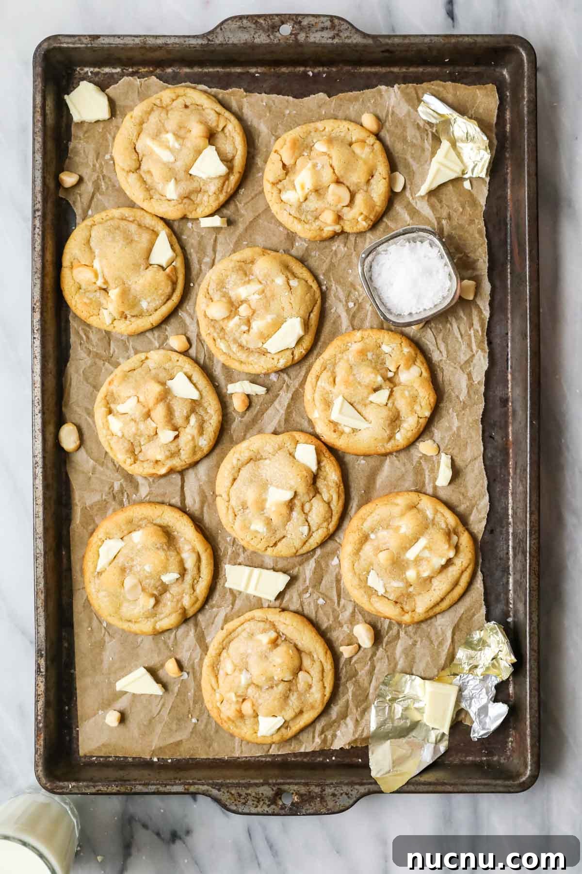 White Chocolate Macadamia Nut Cookies Recipe for Chewy, Crisp Bites 5 Overhead view of a tray of cookies made with white chocolate and macadamia nuts.