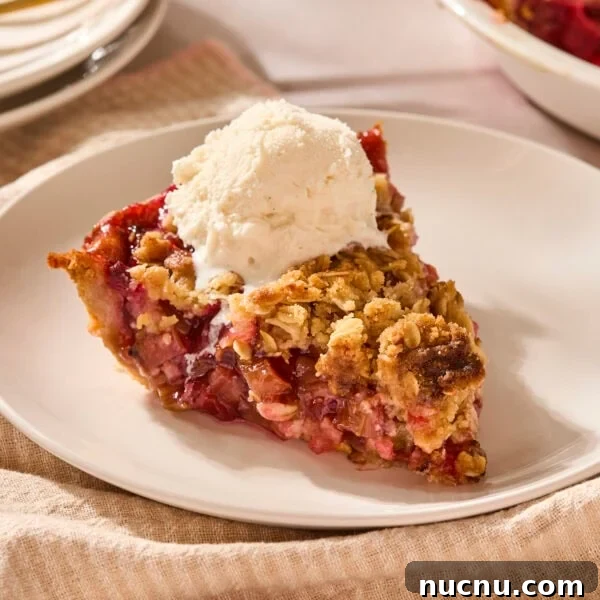 Piece of rhubarb pie with ice cream on top.