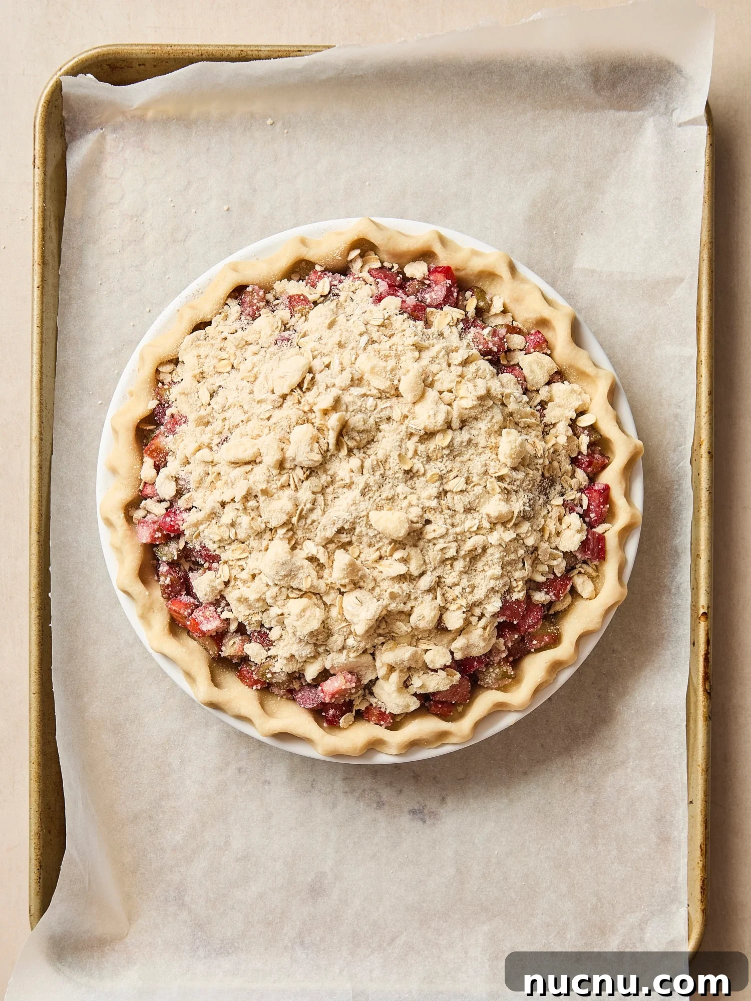 Rhubarb pie with streusel topping before being baked.