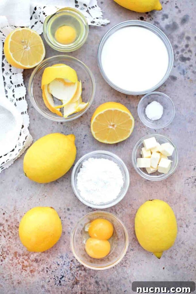 overhead shot of milk sugar eggs lemon butter in bowls on a table