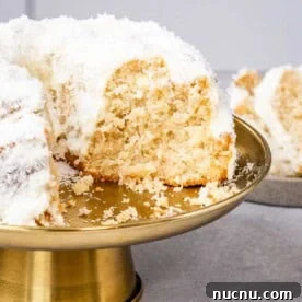 Over 10 Festive Christmas Dessert Recipes for Holiday Gatherings 4 Coconut bundt cake on a gold cake stand.