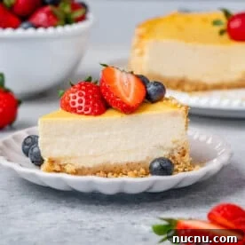 Over 10 Festive Christmas Dessert Recipes for Holiday Gatherings 6 Slice of cheesecake with strawberries and blueberries.
