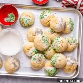 Over 10 Festive Christmas Dessert Recipes for Holiday Gatherings 8 baked Christmas cookies on a sheet pan.