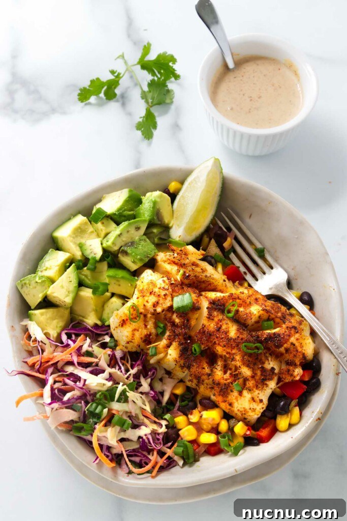 Baja-Style Fish Taco Bowls with Cilantro Lime Slaw 11 A fish taco bowl with corn and bean salsa.