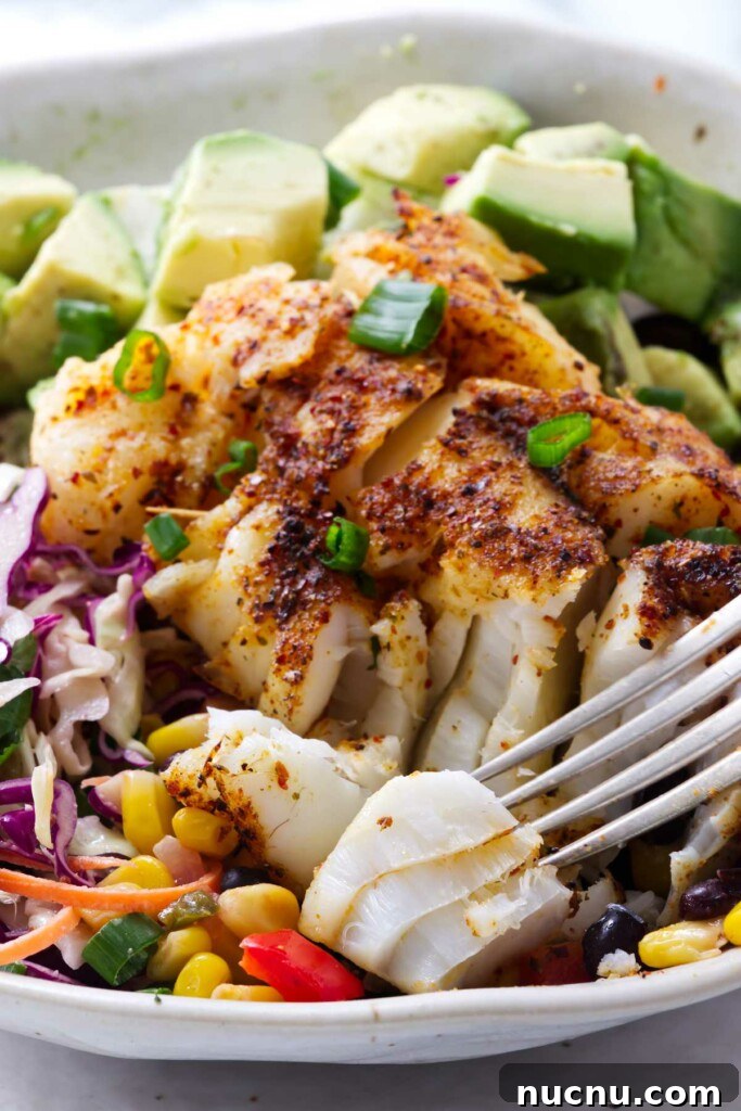Baja-Style Fish Taco Bowls with Cilantro Lime Slaw 3 A piece of fish in a taco bowl.