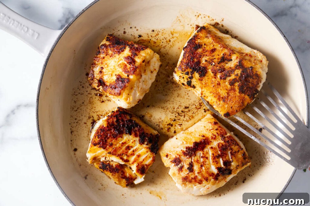 Baja-Style Fish Taco Bowls with Cilantro Lime Slaw 8 Searing cod fillets in a skillet.