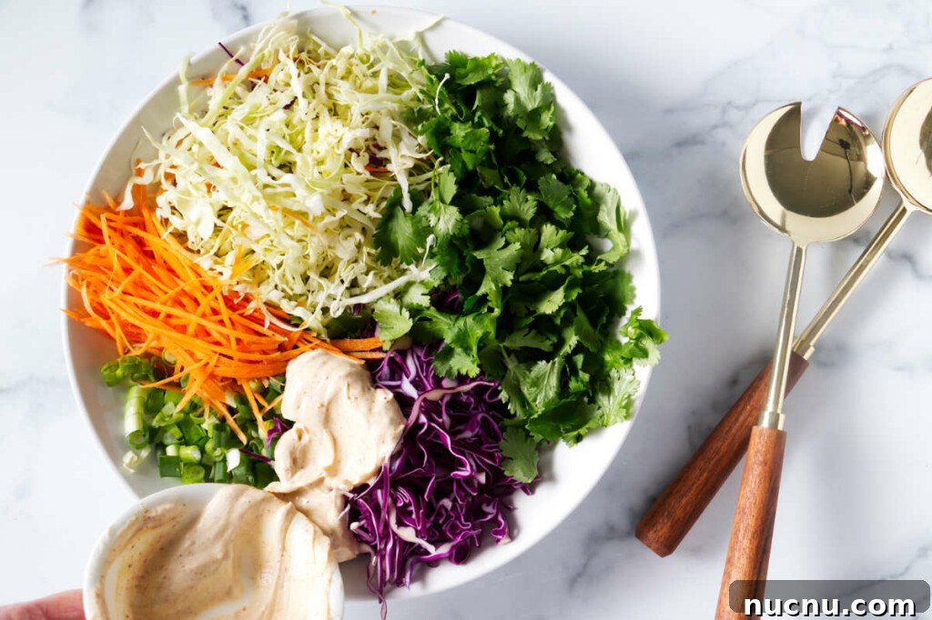Baja-Style Fish Taco Bowls with Cilantro Lime Slaw 10 Pouring the dressing over the slaw for the tacos.