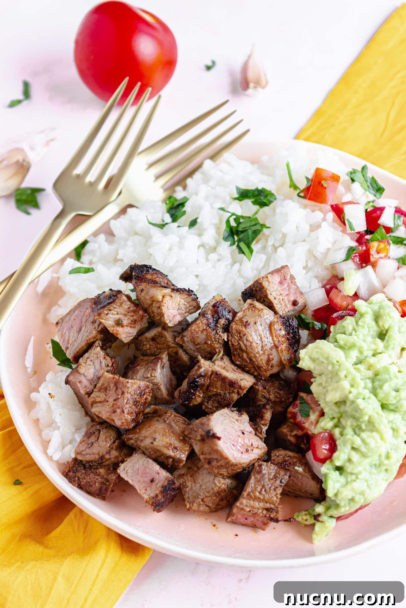 homemade chipotle steak strips next to white rice in a white bowl