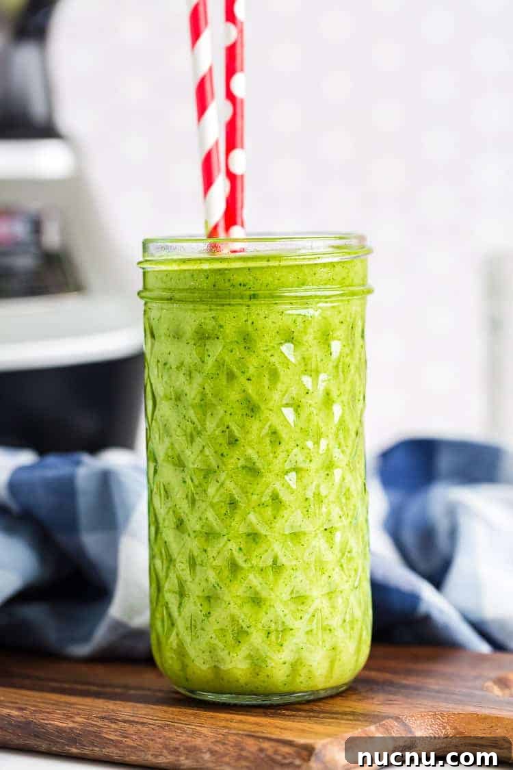 Keto Green Smoothie Vanilla Ice Cream Recipe for Low-Carb Desserts 2 Vanilla Ice Cream Keto Green Smoothie in a tall glass with two red and white straws