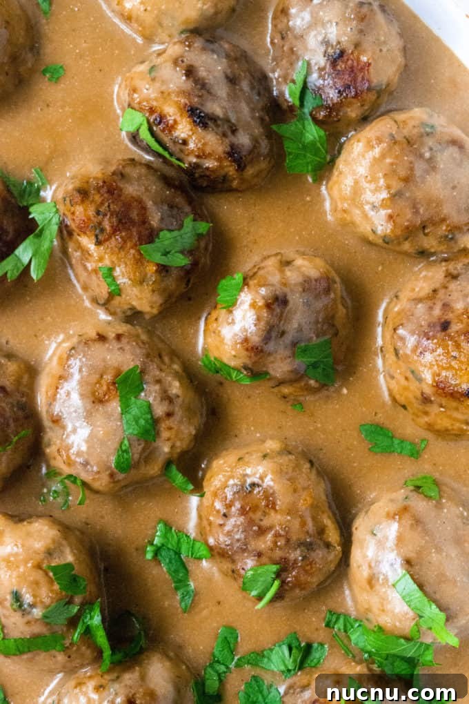 Authentic Swedish Chicken Meatballs Recipe with Creamy Sauce 6 pan of simmering meatballs