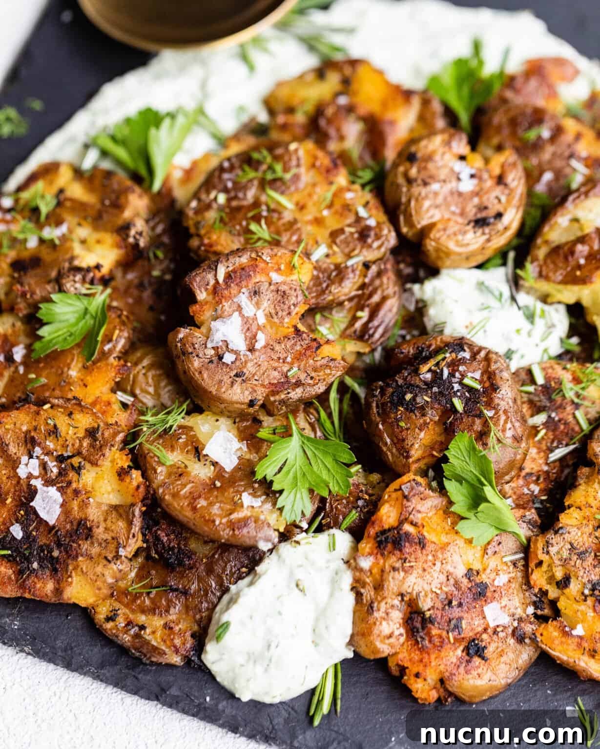 Crispy Smashed Potatoes with Whipped Herb Ricotta Dip 7 smashed potatoes on a serving tray with whipped ricotta