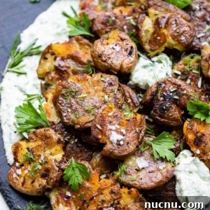 Crispy Smashed Potatoes with Whipped Herb Ricotta Dip 8 smashed potatoes on a serving board