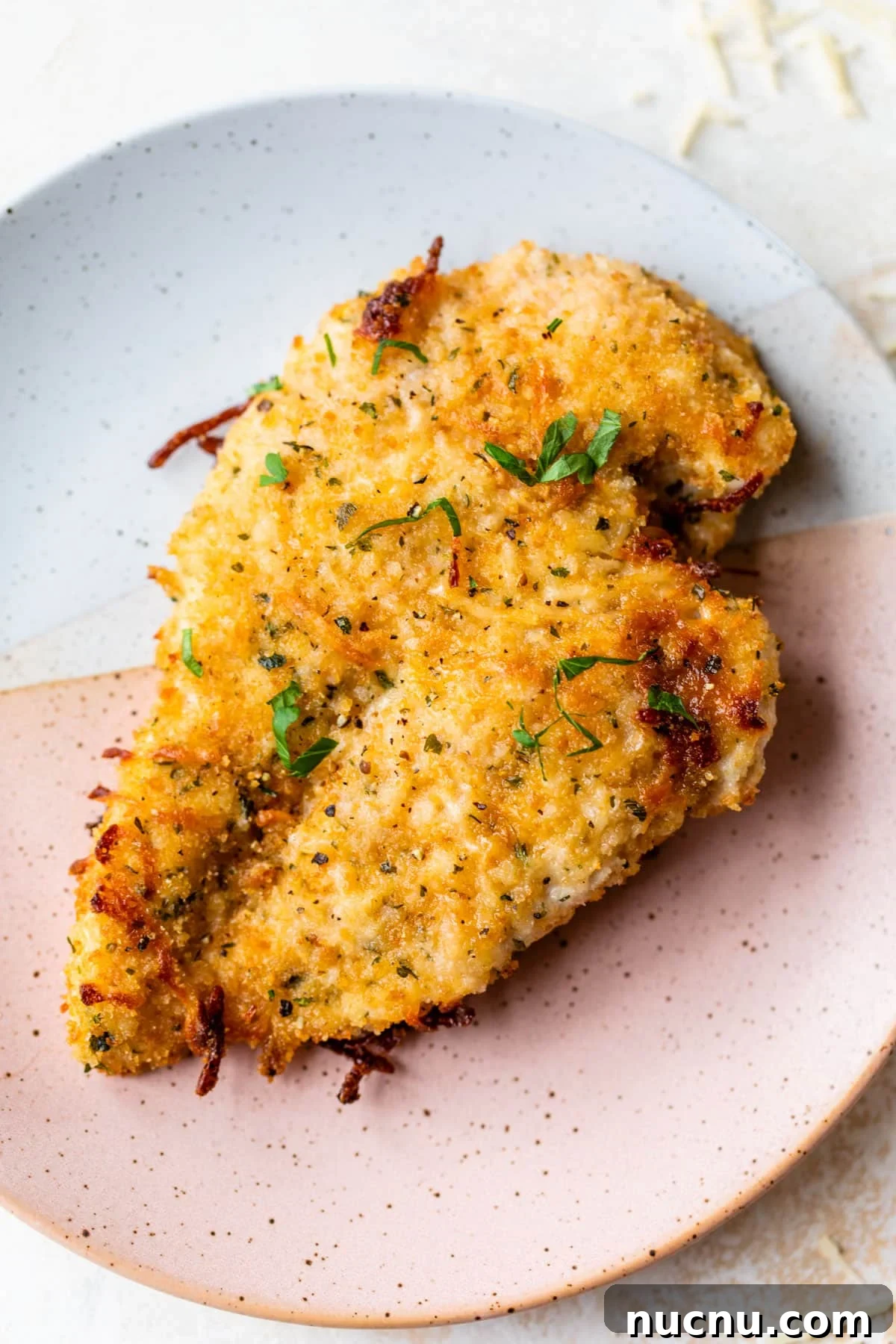 Crispy Baked Parmesan Chicken with Garlic and Herbs 6 baked parmesan chicken on a plate