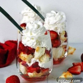 What to Serve with Lasagna: Appetizers, Sides & Desserts 13 Two angel food cake strawberry shortcakes in stemless wine glasses topped with whipped cream.