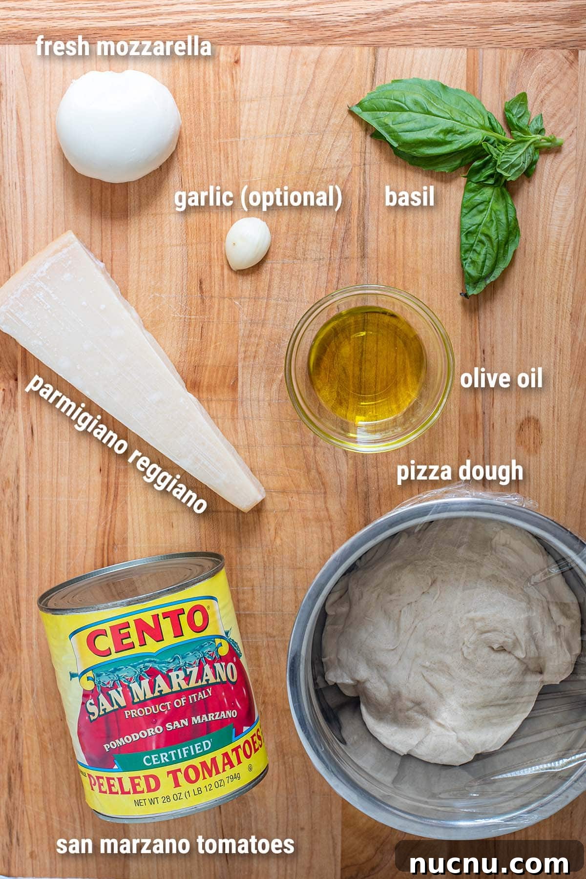 Margherita pizza ingredients laid out on a cutting board.