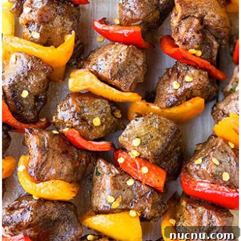 Easy Homemade Grilled Steak Kabobs on Light Brown Dish.