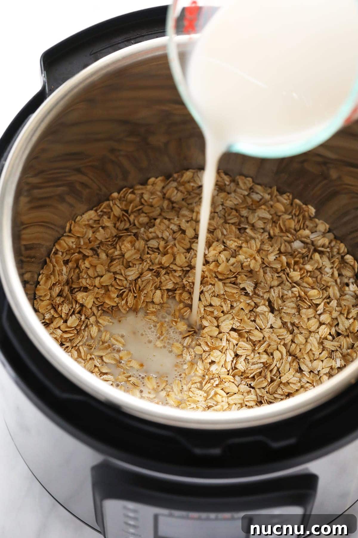 pouring milk into Instant Pot pouring milk into Instant Pot