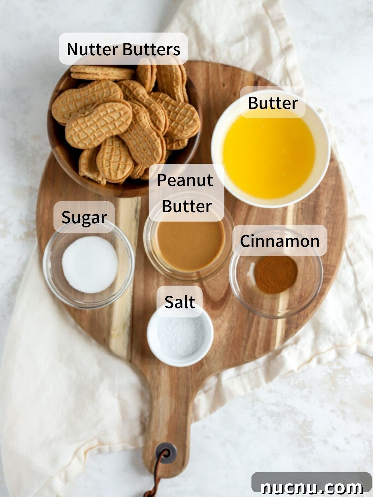 Labeled ingredients needed to make a Nutter Butter crust laid out on a table.