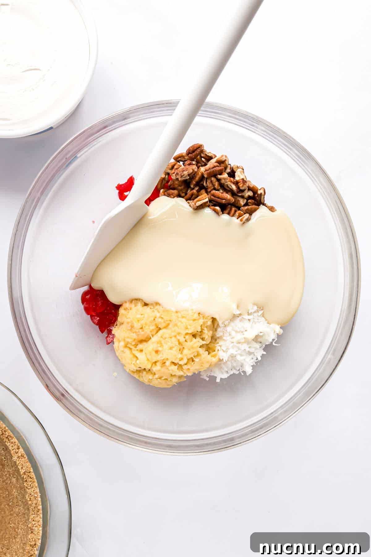 Ingredients, except whipped cream, in a large glass bowl, not yet mixed together.