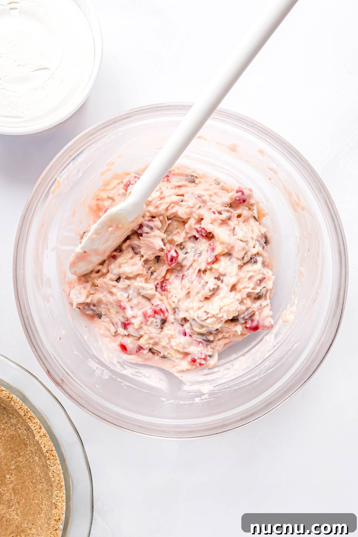 Ingredients, except whipped cream, stirred together in clear glass bowl.
