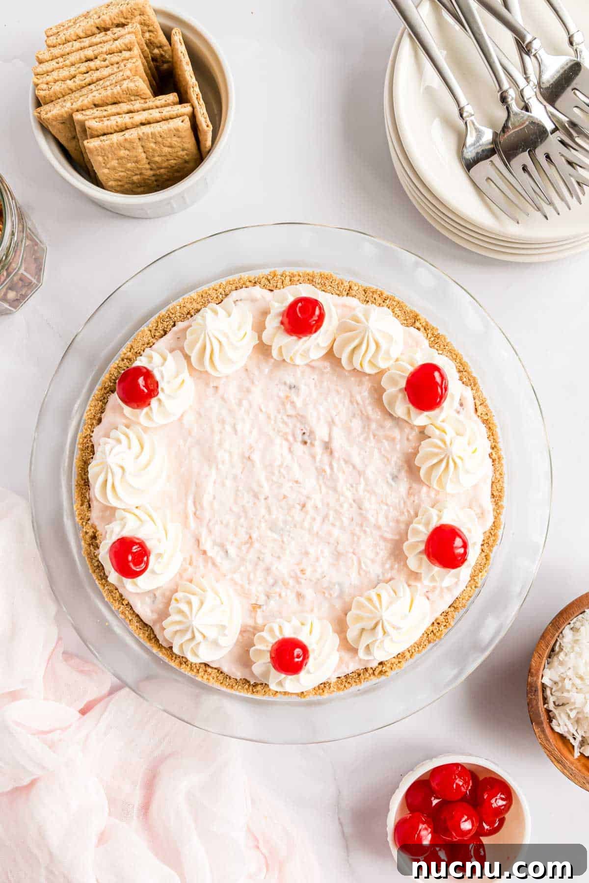 Millionaire pie topped with whipped cream and cherries.