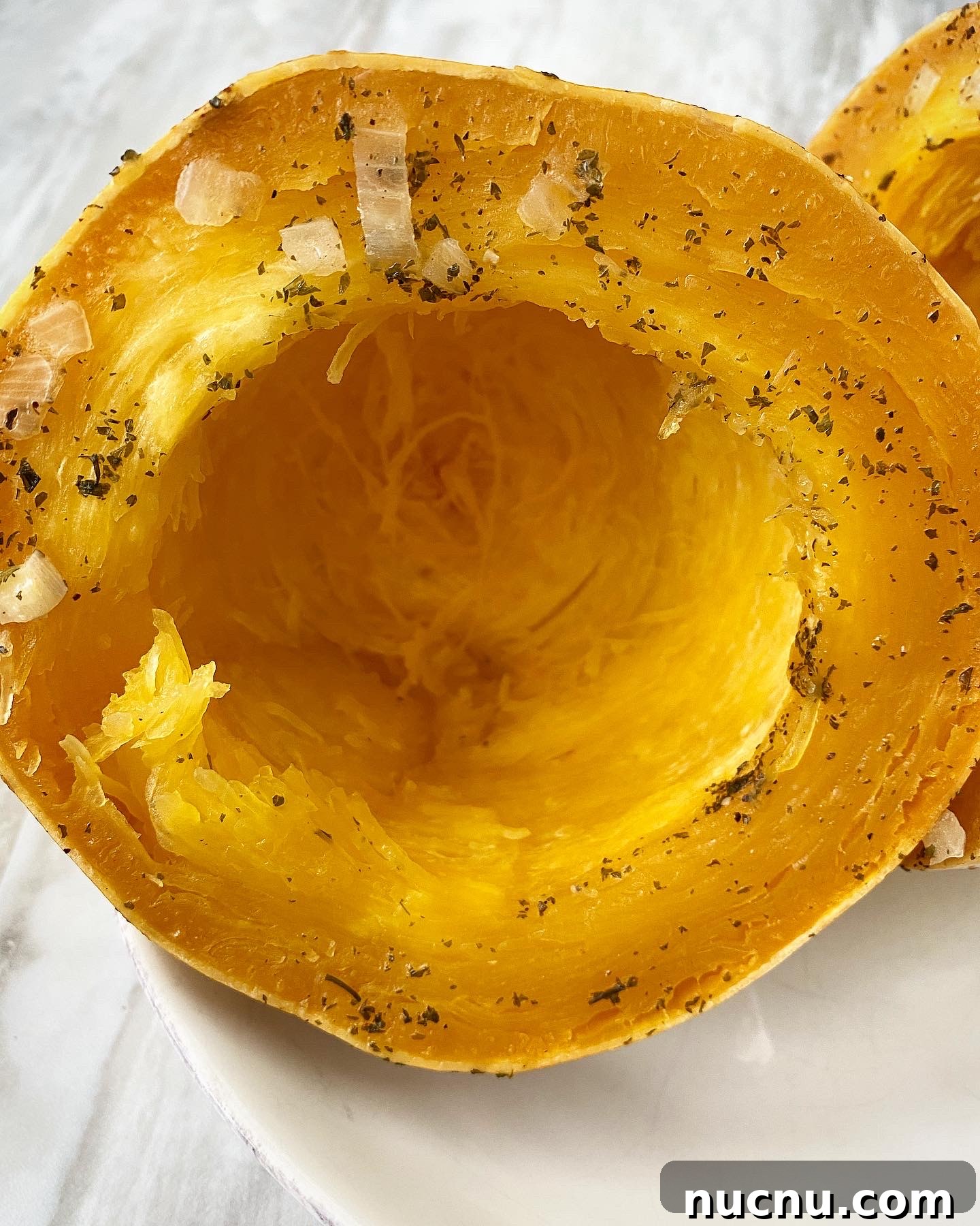 cooked spaghetti squash on a white plate