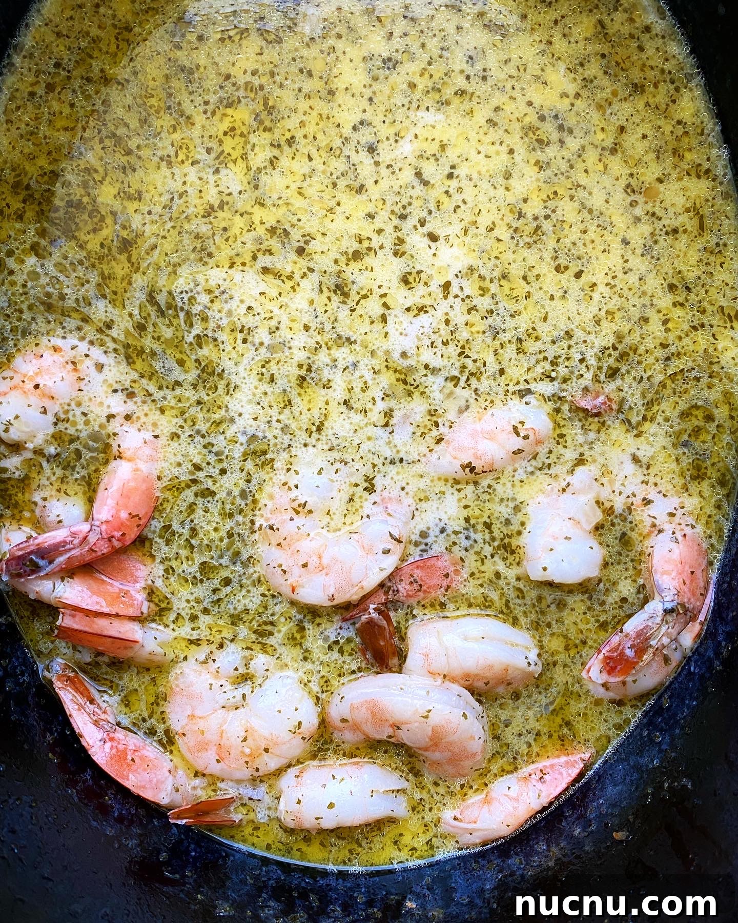 up close cooked shrimp in the scampi sauce in the slow cooker