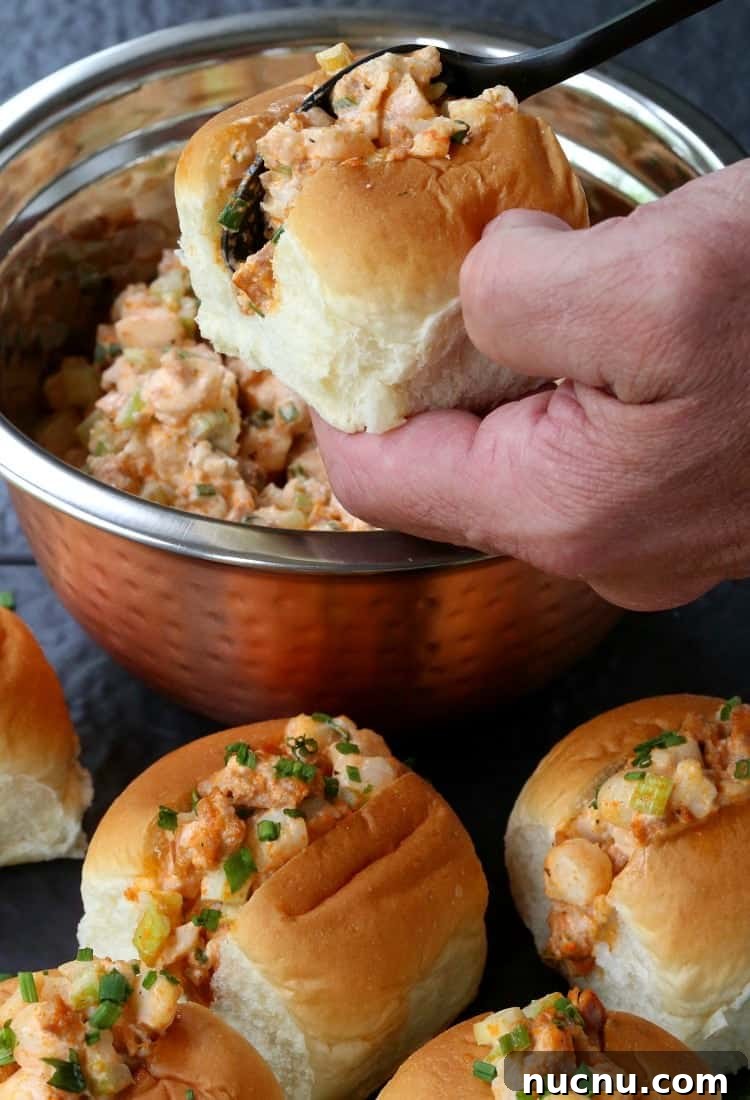 Spicy Shrimp Salad Sliders are so fun for parties! A delicious, creamy shrimp salad kicked up with chorizo and piled into soft sliders buns! shrimp salad bring stuffed into a slider bun