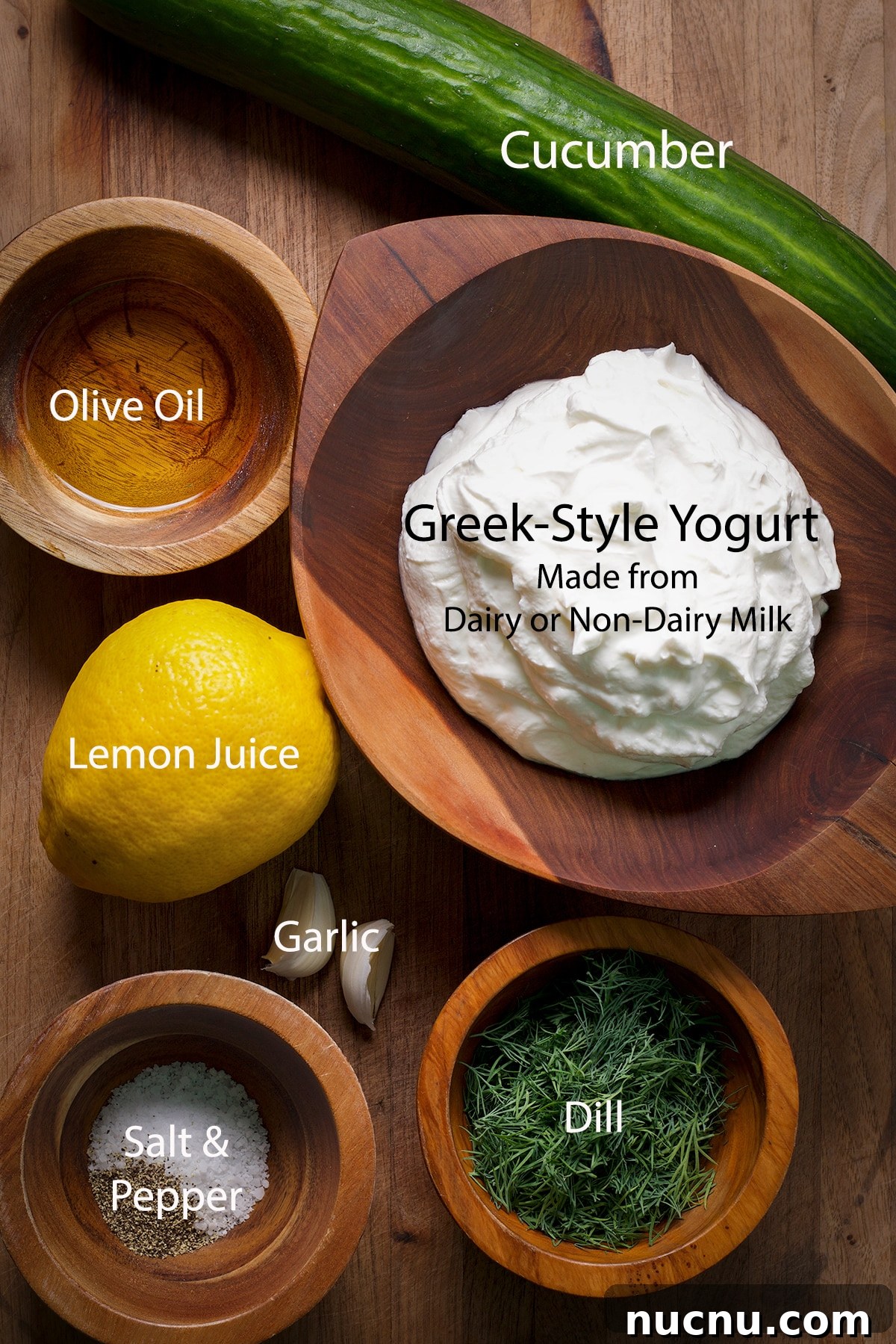 Traditional and Vegan Tzatziki: Authentic Recipes for Both Versions 3 All of the ingredients to make traditional or vegan tzatziki on a wood cutting board.