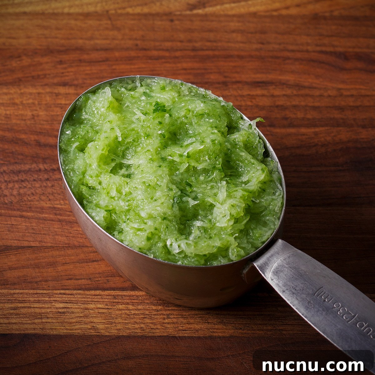 Traditional and Vegan Tzatziki: Authentic Recipes for Both Versions 5 A one-cup measure containing grated cucumber.