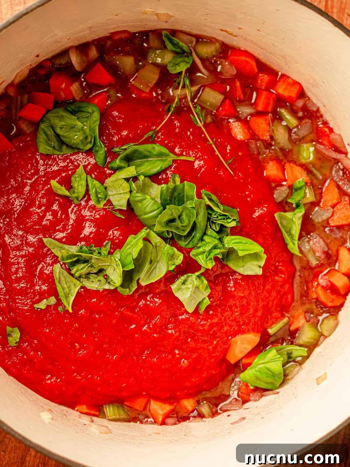 Pot filled with tomatoes, herbs, and vegetables.