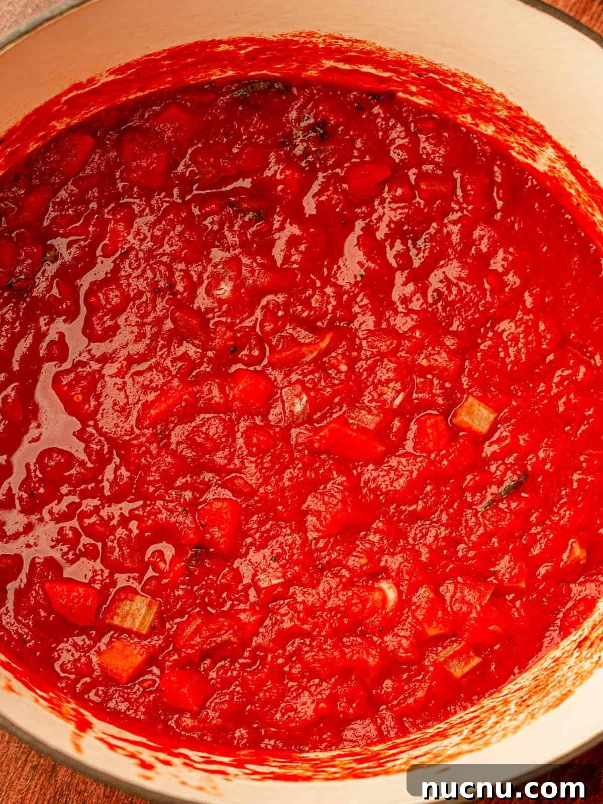 A large pot filled with pasta sauce.
