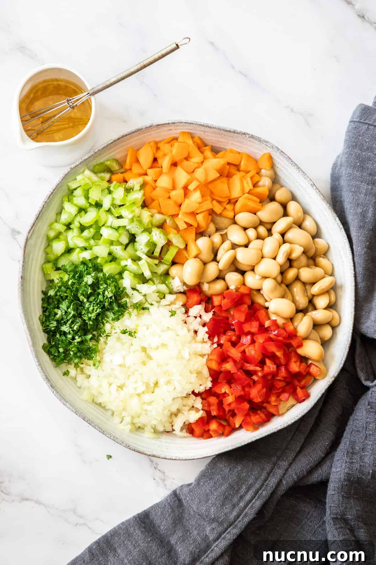 Creamy Butter Bean Salad with Lemon & Herbs — Quick Summer Side 4 Step 1 of preparing this recipe - all of the ingredients in a bowl ready to be tossed with dressing.