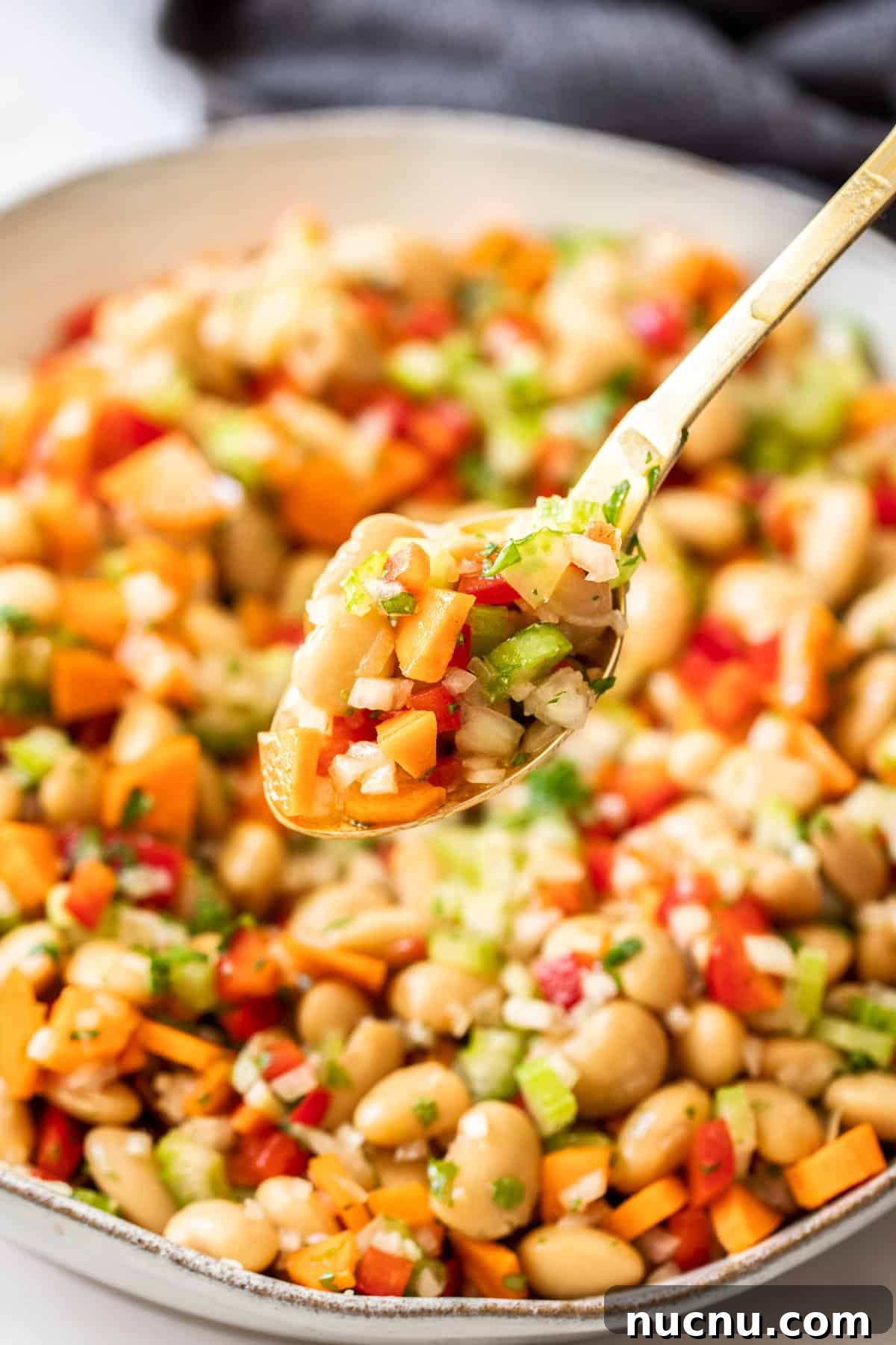 Creamy Butter Bean Salad with Lemon & Herbs — Quick Summer Side 6 Spoon lifting out some Butter Bean Salad from a round bowl.