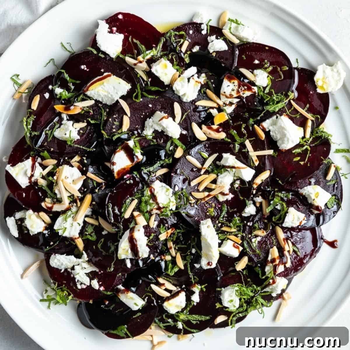 Round white plate with beetroot salad.