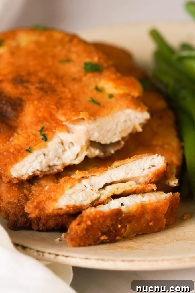 Romano cheese crusted chicken breast cut into slices