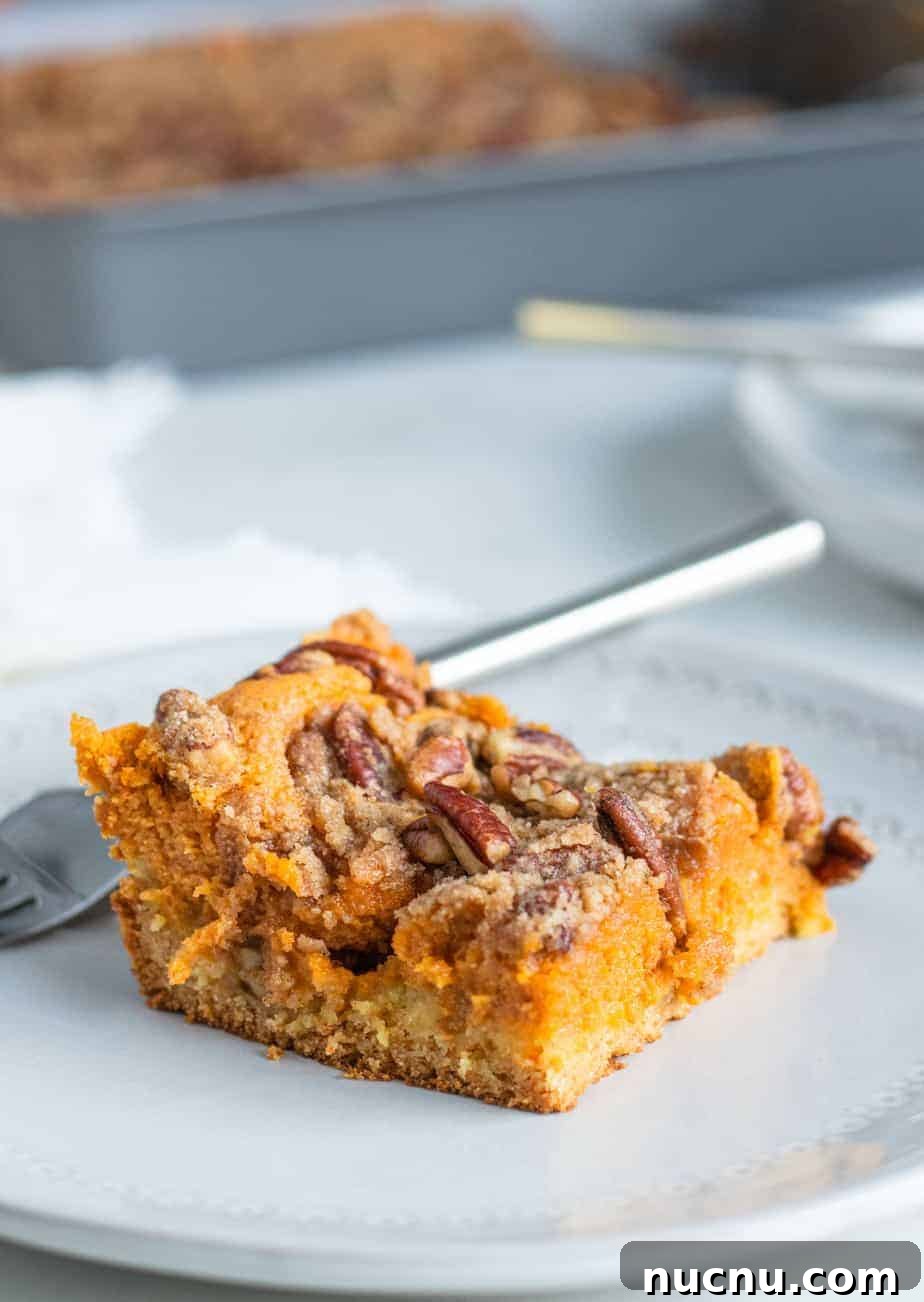 Pumpkin Gooey Butter Cake with Pecan Streusel Recipe 6 close up of gooey butter cake on a plate with a fork