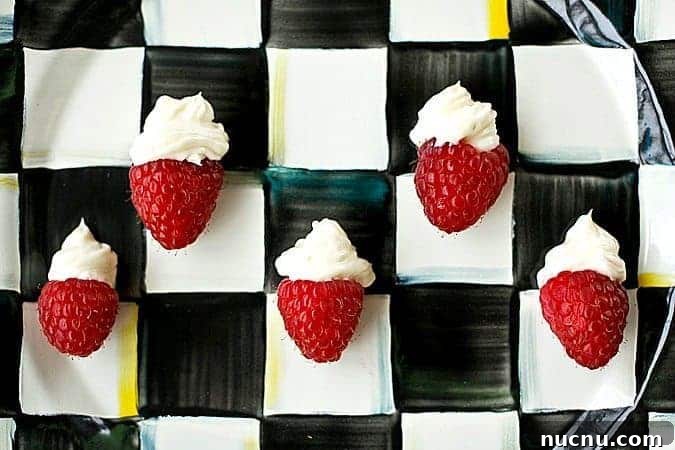 Mini Cheesecake-Stuffed Raspberries: Bite-Sized Dessert Bites 3 One Bite Cheesecake Stuffed Rasperries with Chambord foodiewithfamily.com #cheesecake #Dessert