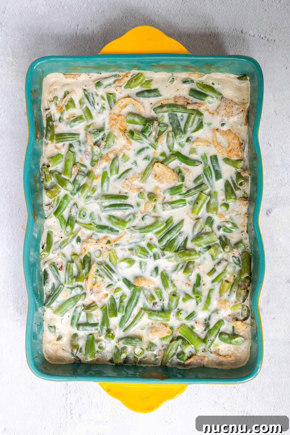 Double Green Bean Casserole Recipe for Family-Sized Meals 5 The green bean casserole filling is baked until warmed through and bubbling.