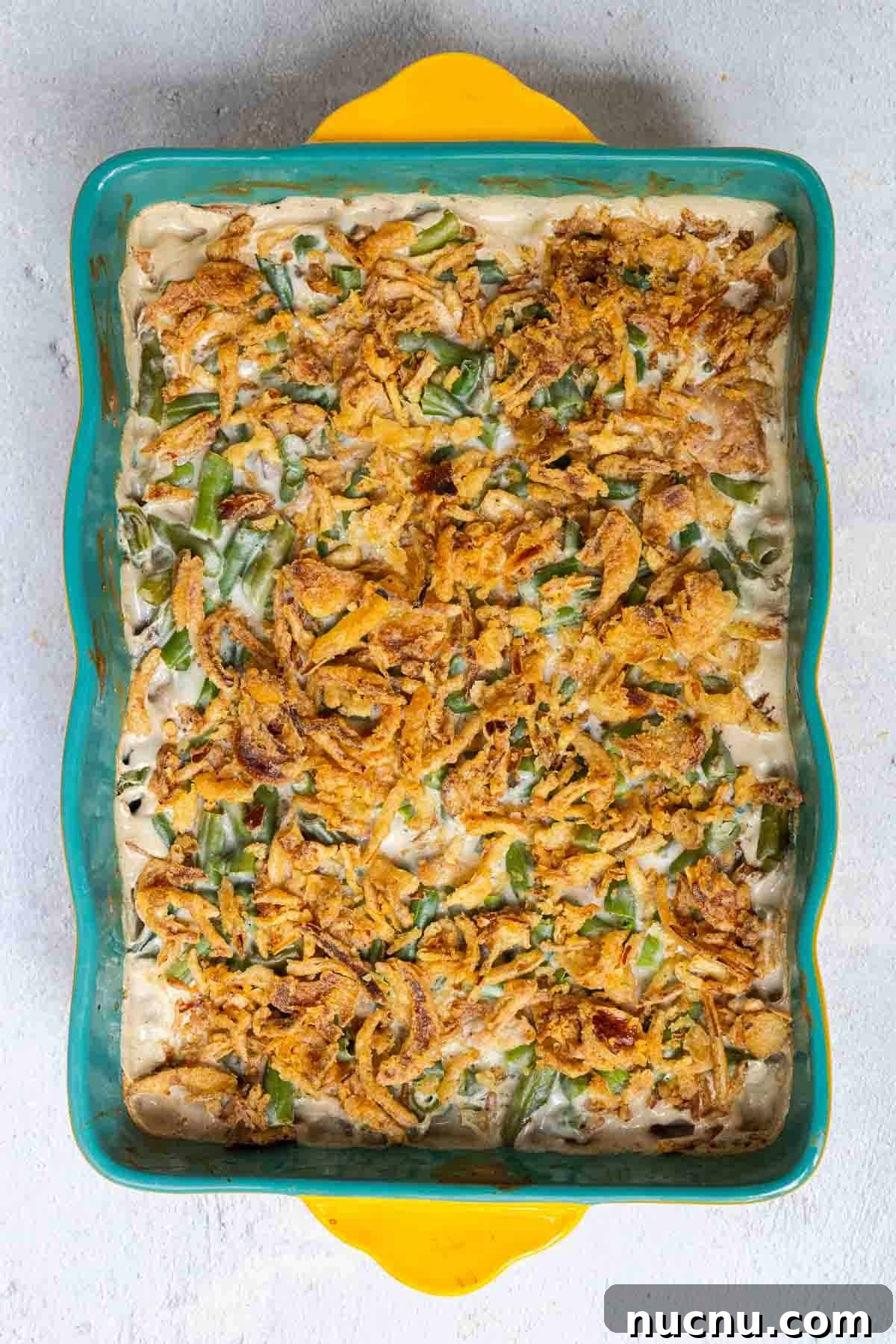Double Green Bean Casserole Recipe for Family-Sized Meals 7 Green bean casserole topped with crispy fried onions is baked until the onions are golden.