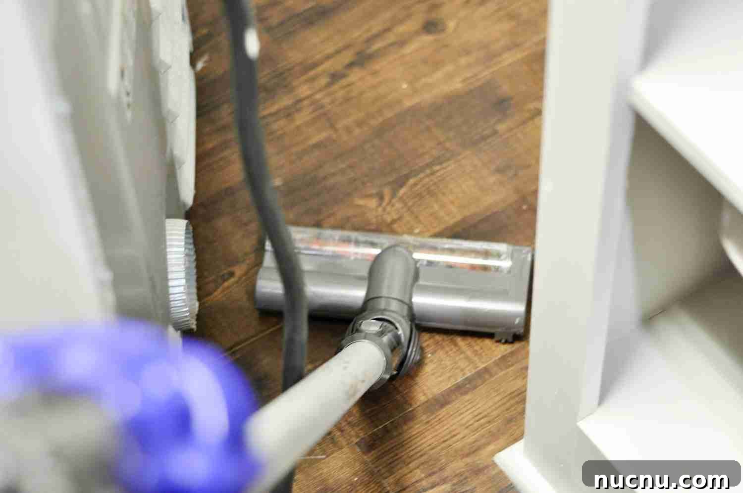 vacuuming behind a dryer