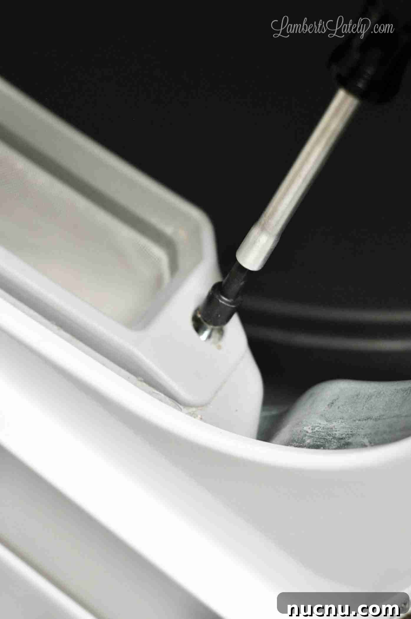 unscrewing lint filter on a speed queen dryer