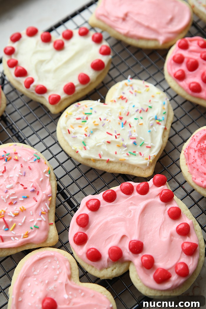 Decorated heart-shaped sugar cookies on a wire cooling rack.