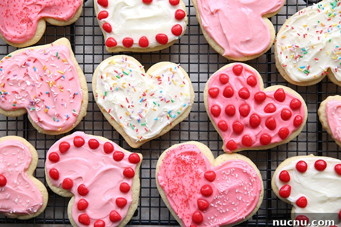Twelve heart-shaped sugar cookies and decorated with sprinkles and Red Hot candies.