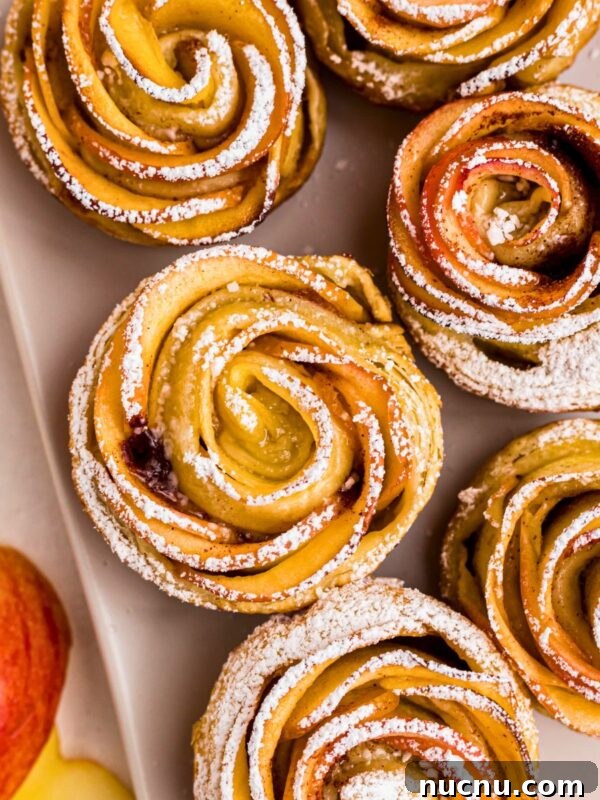 Irresistible Peach Dump Cake Recipe for Quick Summer Desserts 9 Apple roses on a white rectangle plate, then sprinkled with powdered sugar.