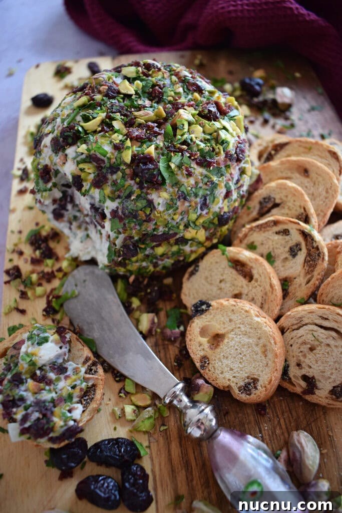 Cranberry Pistachio Goat Cheese Ball Recipe for Parties 17 Goat cheese ball with crackers and a serving knife.