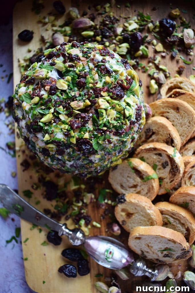 Cranberry Pistachio Goat Cheese Ball Recipe for Parties 3 Goat cheese ball with crackers on a board.