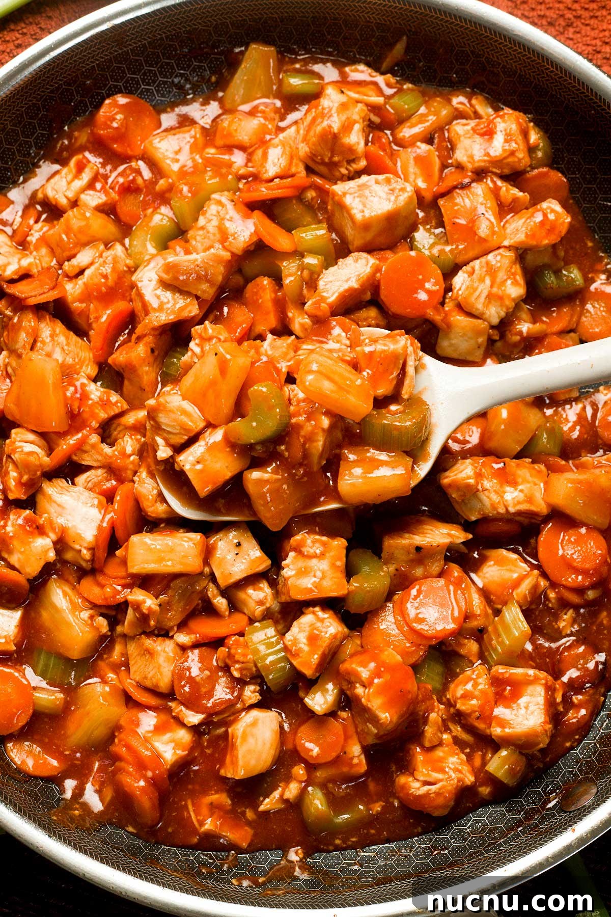 Gluten-Free Sweet and Sour Chicken Made in a HexClad Pan 11 Healthy Gluten-Free Sweet and Sour Chicken in a frying pan.