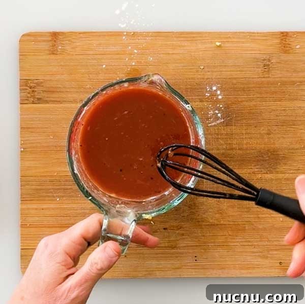 Gluten-Free Sweet and Sour Chicken Made in a HexClad Pan 5 Stirring sweet and sour sauce.