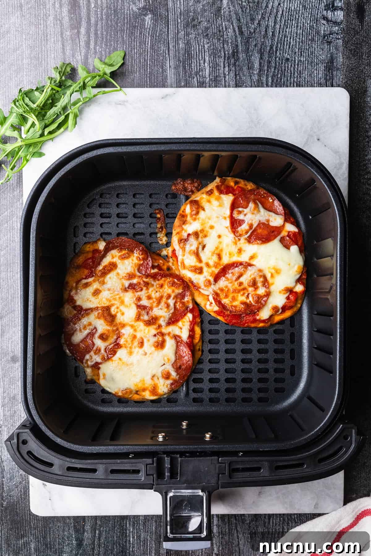 Crispy Air Fryer Naan Pizza Recipe for Quick Weeknight Meals 6 Air fryer pizza with golden brown melted cheese.